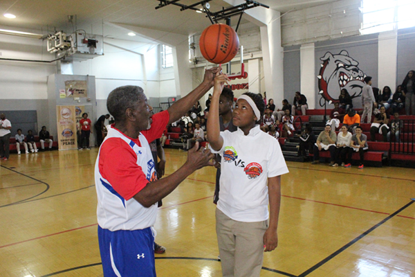 Young basketball player spinning a ball on his finger.
