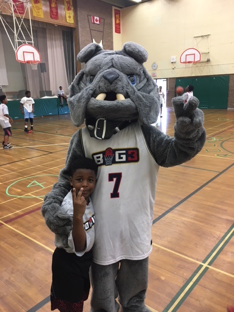 Big3 Mascot posing with young participant